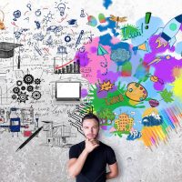 Creative and analytical thinking concept. Thoughtful man with colorful sketch on concrete background